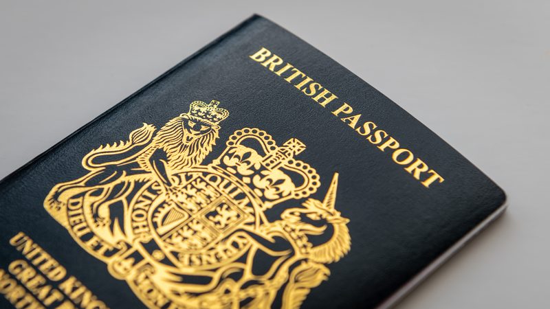 British passport with the royal coat of arms on the cover, representing British Citizenship at KMT Solicitors