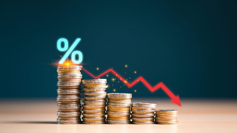 Coin stacks falling in height beside a percent sign and a red downward arrow, representing Bankruptcy Petitions at KMT Solicitors