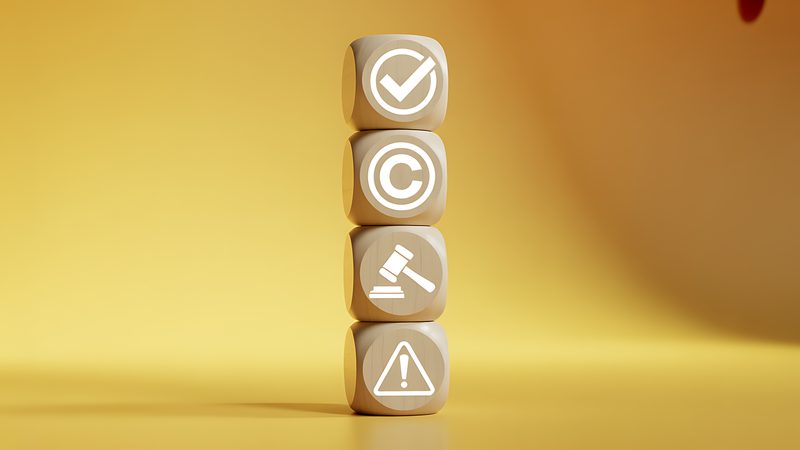 Stacked blocks with tick, copyright, gavel and warning symbols, representing Licensing at KMT Solicitors