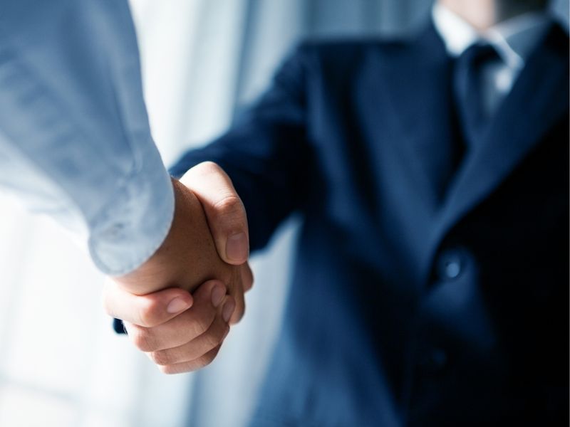 Business handshake, representing commercial and corporate law at KMT Solicitors