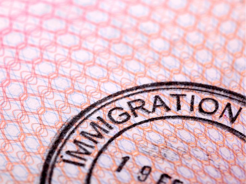Immigration stamp in a passport, representing immigration advice at KMT Solicitors