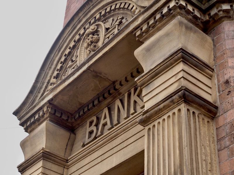 Carved stone entrance of a historic bank building, representing insolvency advice at KMT Solicitors