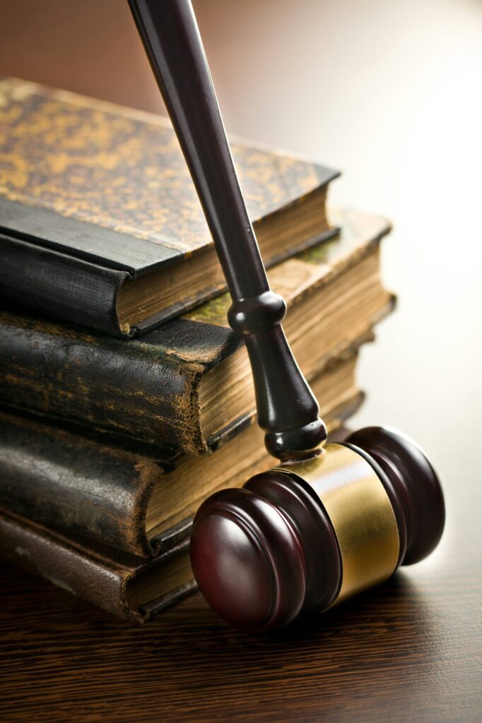 Judge’s gavel in front of old law books